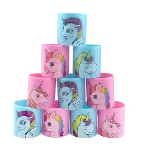 Pyramid stack of colorful rainbow spring toys featuring unicorn patterns on white background