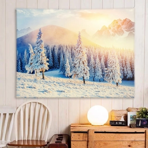 Detail of winter snow scene tapestry showing golden sunlight on snowy pine forest