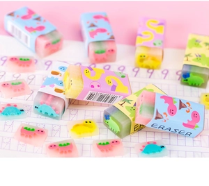 Close-up of translucent dinosaur jelly erasers in various shapes on a pink desk