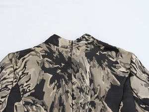 Detailed view of elegant black and gold jacquard fabric with a hidden back zipper
