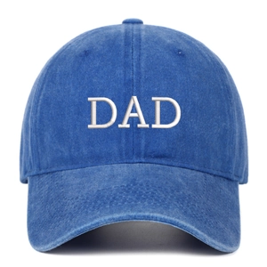 Macro shot of white DAD embroidery on a vintage washed blue cotton baseball cap