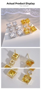 Detailed view of layered geometric cubic zirconia earrings in gold and silver finishes
