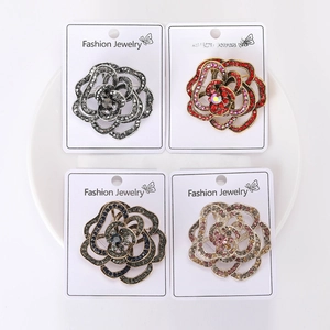 Macro shot of four floral crystal brooches in assorted colors on display cards