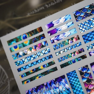 Metallic nail art stickers with peacock feather and fish scale textures in gradient tones