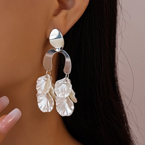 Chic silver earrings featuring oversized pearlescent white flower petals and tassel design