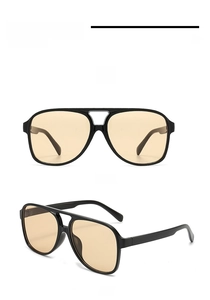Front and side view of oversized black aviator sunglasses with orange tinted lenses