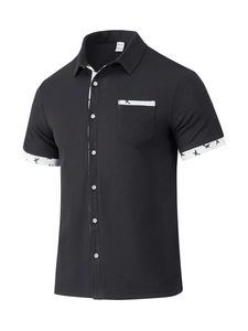 Close-up of black waffle knit shirt with floral lining on collar and 100% polyester tag