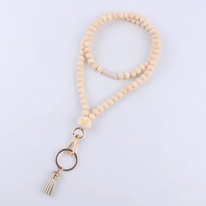 Detail of wooden beads lanyard with engraved bear pattern, tassel, and gold keyring