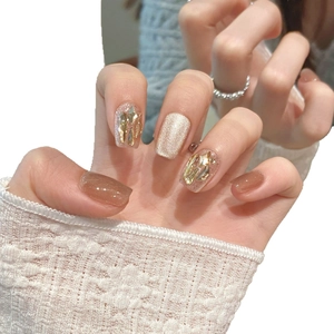 Sparkling champagne cat-eye press-on nails with gold glitter and foil in long square shape