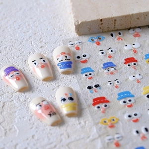 Cartoon facial expression nail art stickers with cute Japanese style designs on light nails
