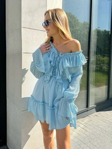 Detail of light blue chiffon dress featuring drawstring V-neck and ruffled long sleeves