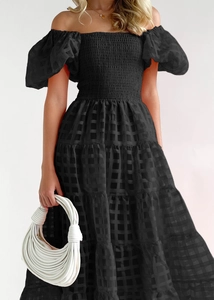 Detail of black off-shoulder plaid dress with puff sleeves and layered tiered skirt