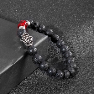 Men's volcanic stone beaded bracelet with Hamsa charm on black gift box