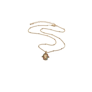 Detailed view of gold Hamsa pendant necklace with colorful gems and beaded chain