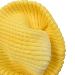 Macro shot of bright yellow knit beanie showing dense ribbed texture and warm fabric details