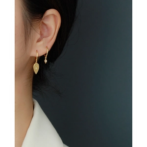 Detail view of S925 sterling silver geometric teardrop earrings with crystals on model