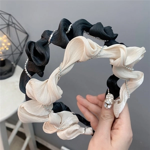 Elegant ruffled headband with silver rhinestone chain trim in black and beige colors