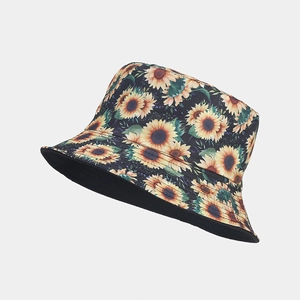 Detailed close-up of sunflower print pattern on black canvas reversible bucket hat