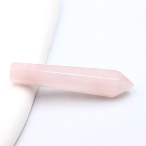 Macro-opname van gepolijste roze kwartskristal punt met glad oppervlak en scherpe punt