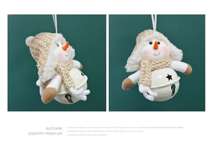 Detail of plush snowman Christmas tree pendant with knit hat and metal star bell
