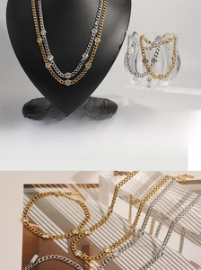 Detailed view of gold and silver cuban link chains with round zircon inlays