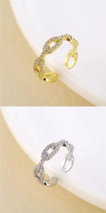 Detailed view of gold and silver mariner link rings with pavé cubic zirconia