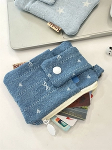 Blue denim card holder with white stars featuring a zipper pocket and metal hook clasp