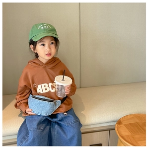Kids denim waist bag worn as a stylish crossbody pack with brown hoodie and casual outfit