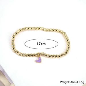 Detailed view of golden bead bracelet with purple heart pendant showing 17cm length