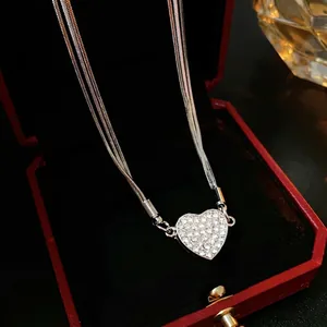 Sparkling diamond-set heart layered necklace in a premium red jewelry display box