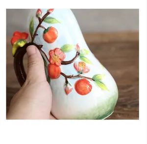 Close-up of ceramic bottle featuring 3D relief fruit patterns and a faux-twig handle