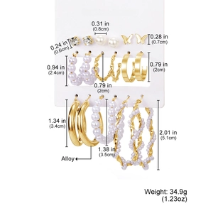 Detail showing 9 pairs of gold butterfly and pearl earrings with specific size dimensions