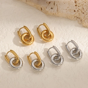 Minimalist double hoop earrings in gold and silver stainless steel on stone background