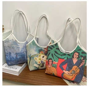 Detailed close-up of three artistic oil painting canvas tote bags on a wooden shelf