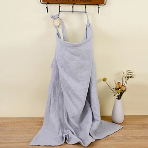Detail of grey cotton muslin nursing cover with adjustable wooden ring buckle