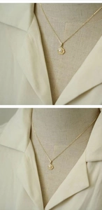 Detailed macro view of S925 silver shell pendant with pearl and 14k gold chain necklace