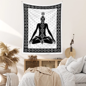 Detailed view of bohemian yoga tapestry with chakra symbols hanging in a modern bedroom