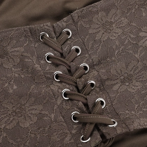 Macro view of floral lace fabric with metallic eyelets and cross-tie ribbon detail