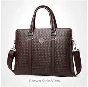 Detail of dark brown business briefcase with embossed patterns and logo metal plate