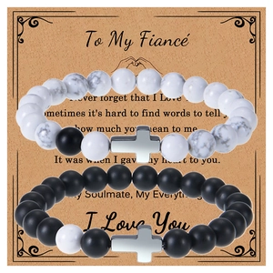 Couples beaded bracelets with white turquoise, matte black stone, and silver cross pendants