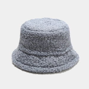 Close-up of soft light blue teddy fleece material on a winter bucket hat for women