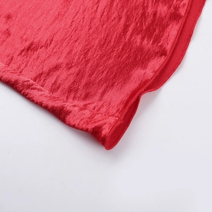Macro shot of red velvet dress fabric showing premium texture and fine sewing details