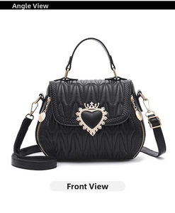 Detailed shot of a black quilted bucket bag featuring a gold heart crown buckle closure