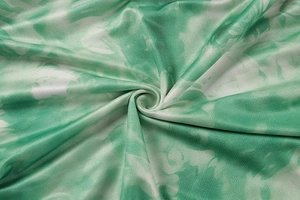 Detailed macro view of the green and white tie-dye textured fabric on bikini set