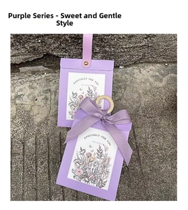 Detail of purple floral wedding gift boxes with leather handle and ribbon bow