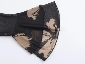 Detail of mesh flare sleeve with ruffled cuffs and abstract brushstroke print pattern