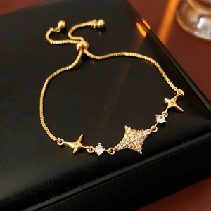 Detailed macro view of gold starburst bracelet with zircon paving and adjustable slider