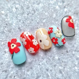 Detail view of 5D embossed floral nail stickers featuring blue and red poppy flower patterns