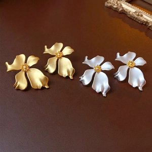 French vintage matte flower stud earrings in gold and silver finishes on leather