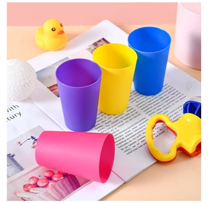 Close-up of colorful matte stackable educational cups for toddlers in a playful setup